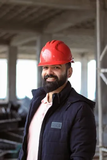 A man wearing a red hard hat and jacket